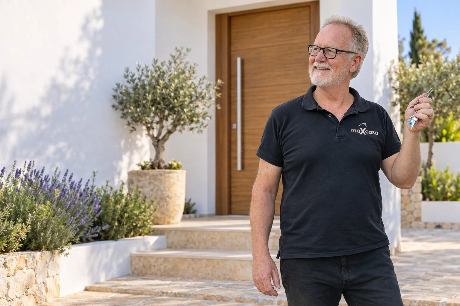 Max, founder of maXcasa International, holding the keys at the entrance to a villa